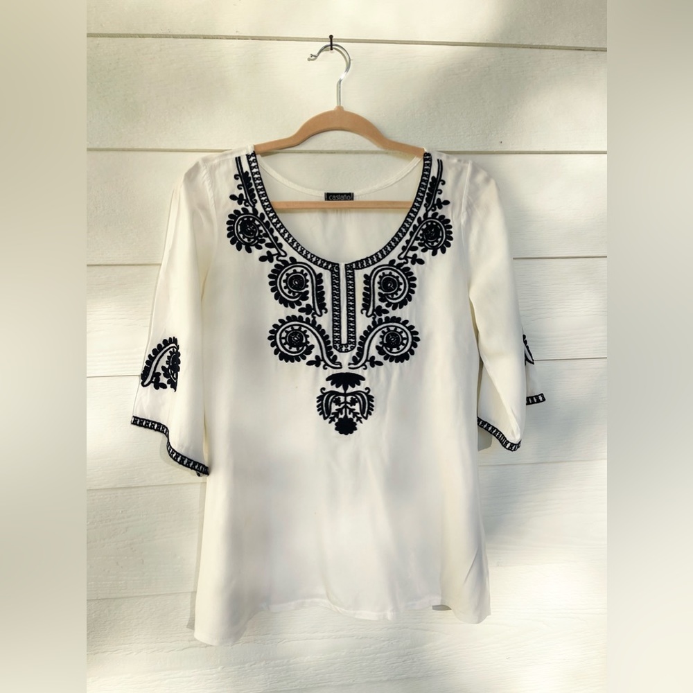 White tunic top from France with navy embroidered detailing. Size small